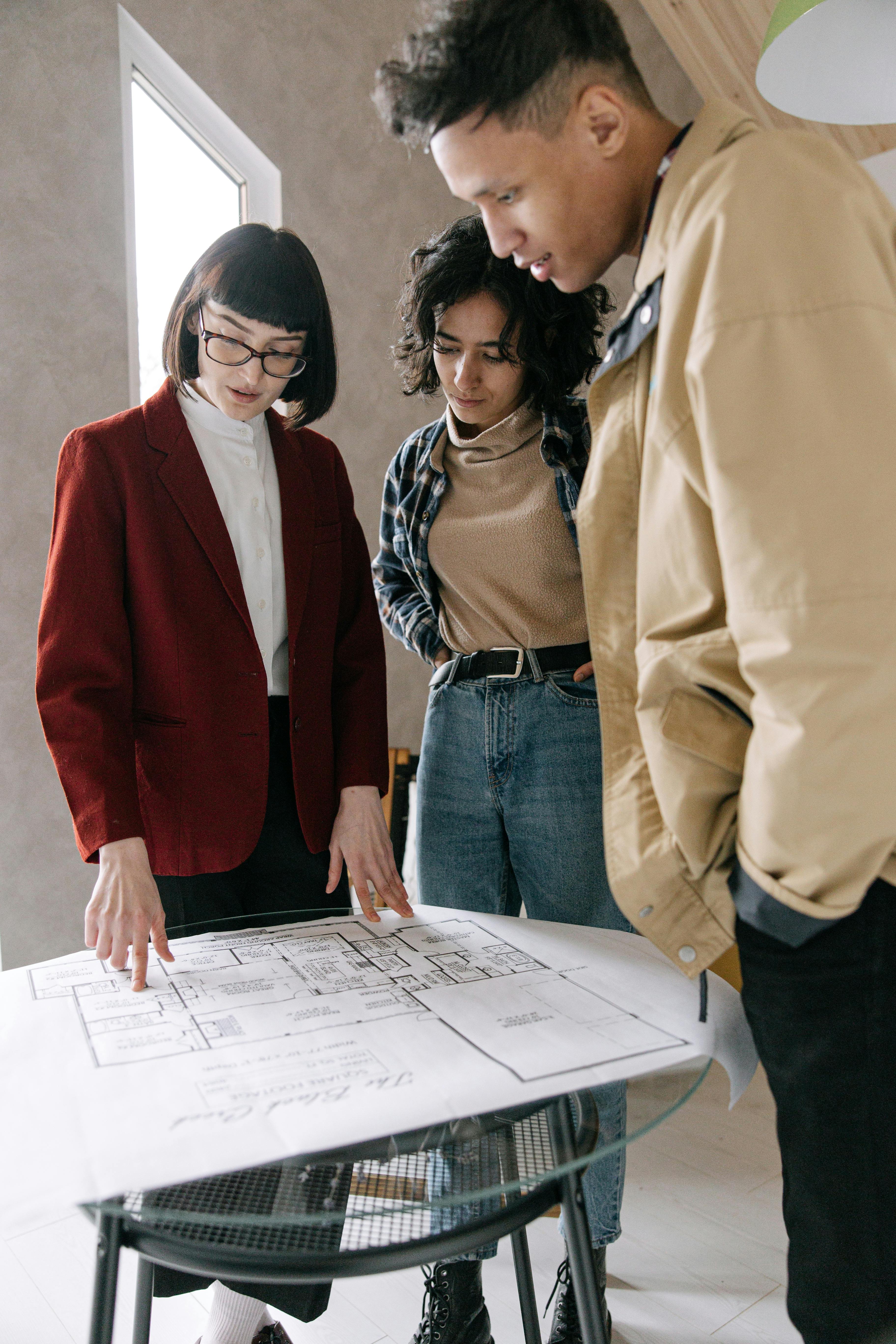 People reviewing architectural plans at a table